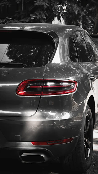 Rear view of a sleek, dark grey luxury suv.