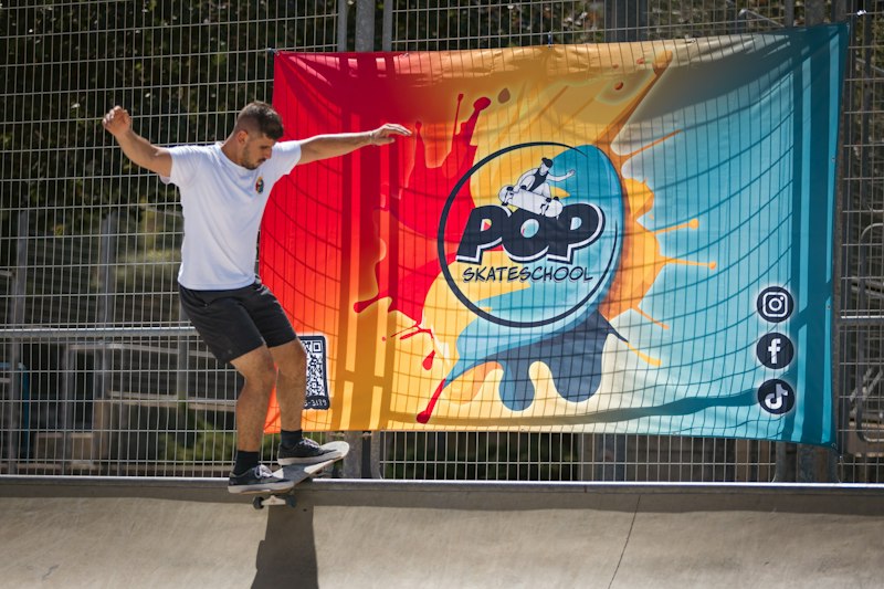 Colourful event banner hanging on a fence
