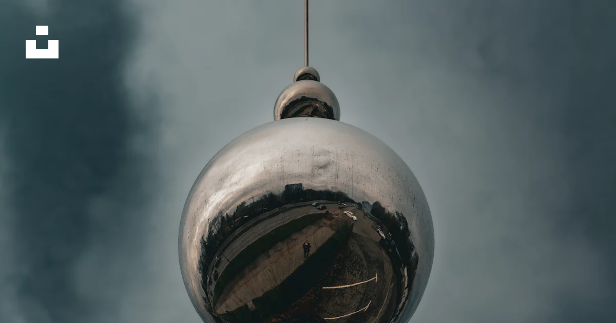 Sphereical Column A reflective spherical structure atop a red column. photo – Free ...