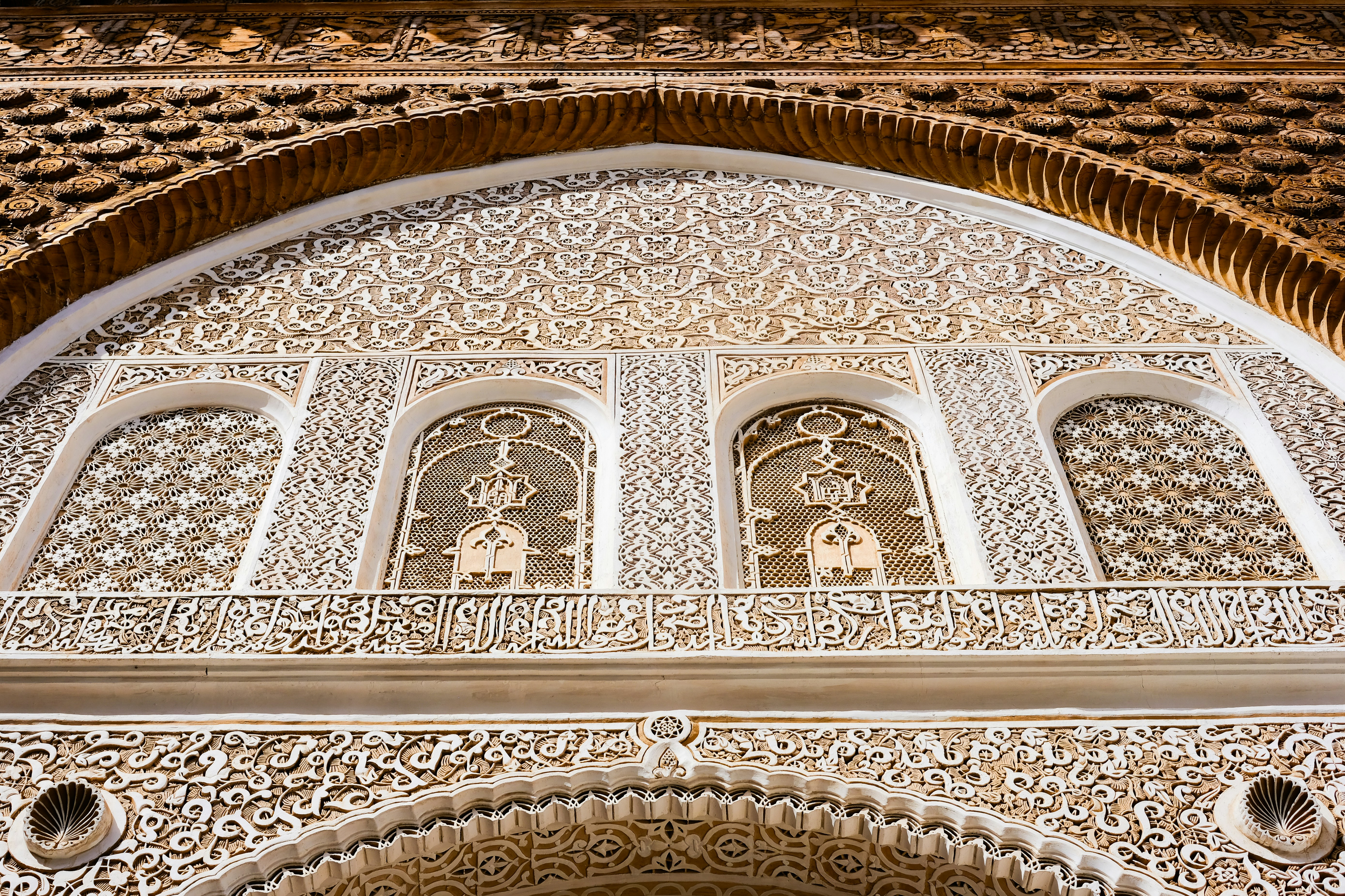 Intricate arabic calligraphy adorns an ornate archway.