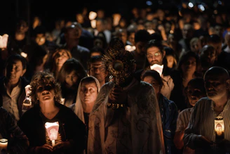 A religious procession with people holding candles