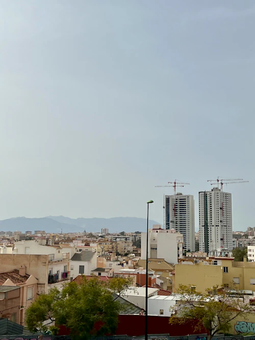 City skyline with construction cranes on tall buildings — placeholder photo, replace with actual report cover