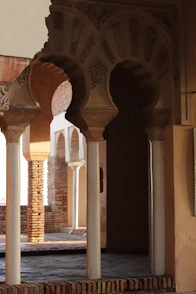 Arched entryway with ornate details and columns.