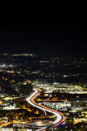 Long exposure of a highway at night with city lights