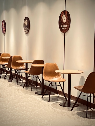 Modern cafe seating area with tables and chairs.