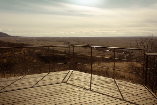 Wooden deck overlooking a vast, flat landscape.