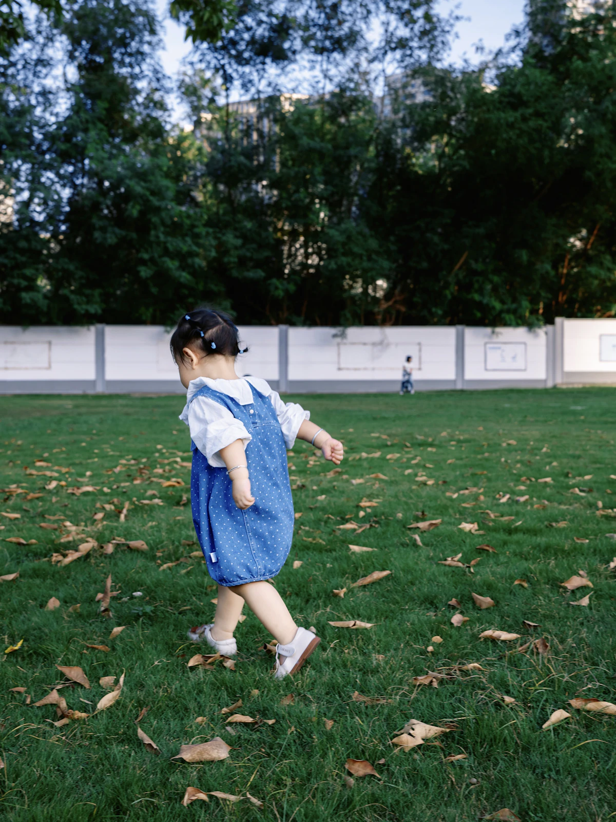 Child walking freely on grass in nature