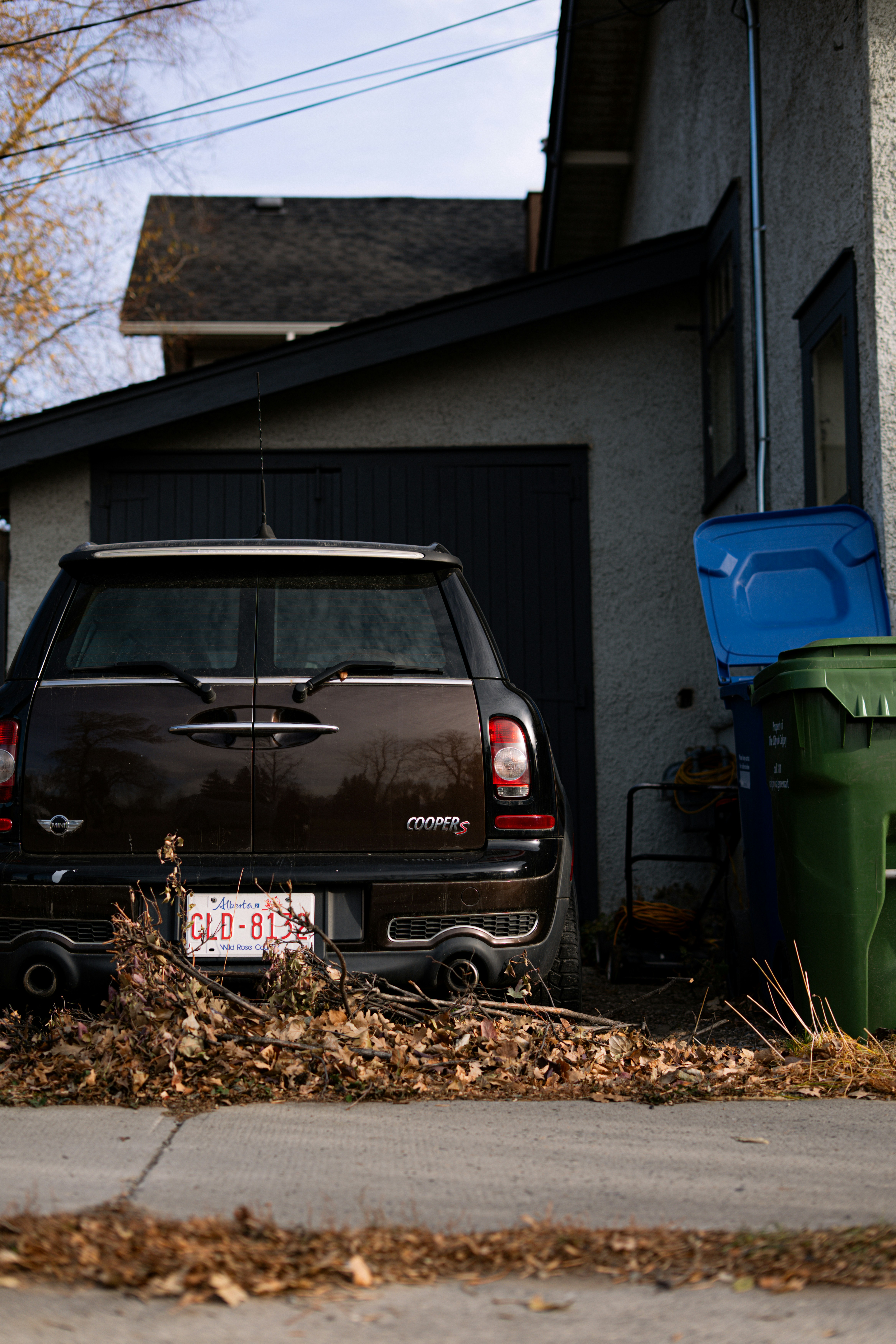 Vehicle owner checking documents to sell junk car without registration beside an old non-running car