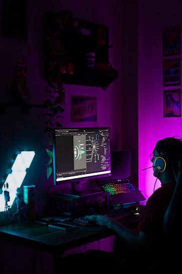 Person gaming with colorful rgb keyboard and monitor
