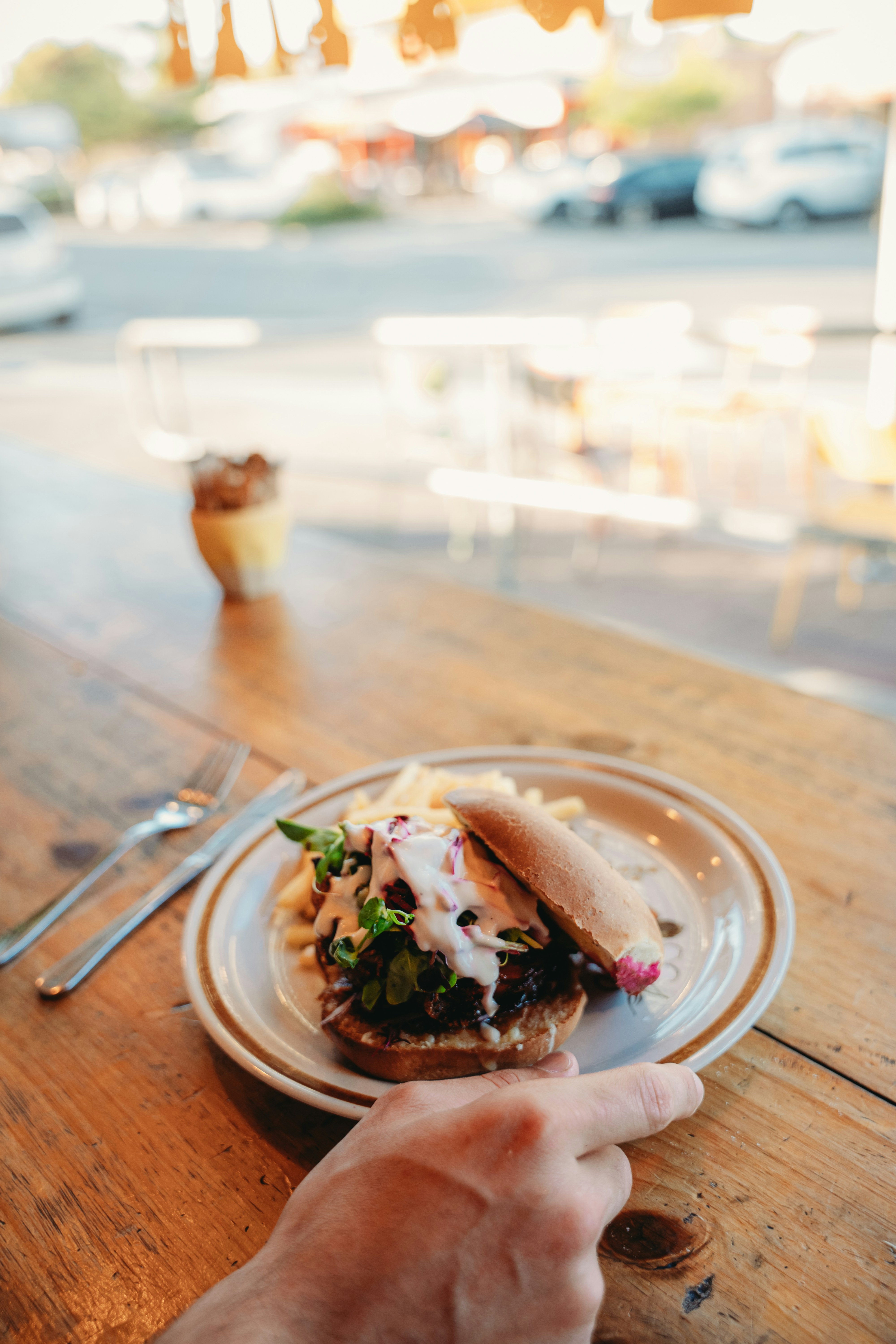 A delicious burger and fries served on a plate.