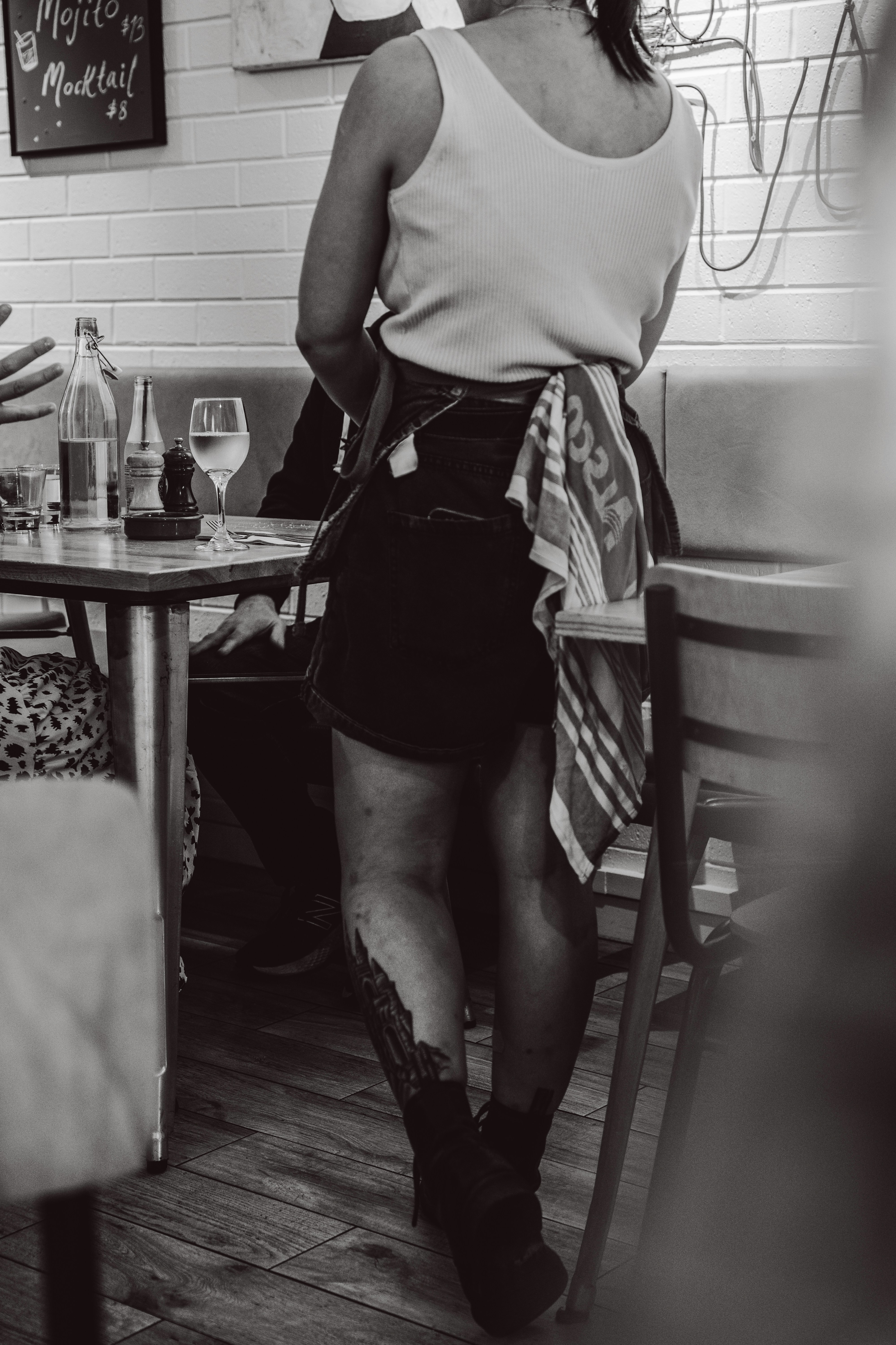 Waitress in uniform standing in a restaurant.