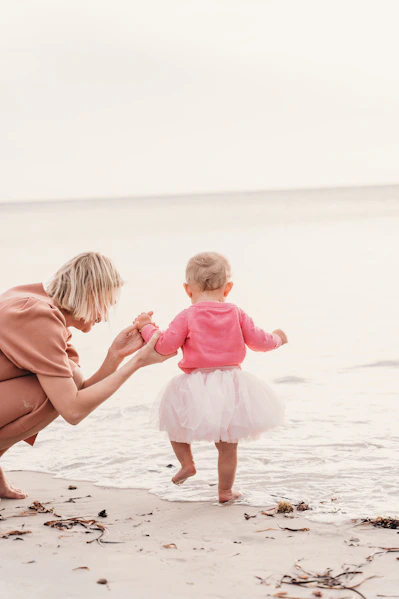 Mother and child walking on a beach