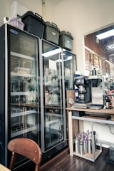 Commercial refrigerators stocked with beverages and supplies.