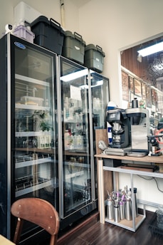 Commercial refrigerators stocked with beverages and supplies.