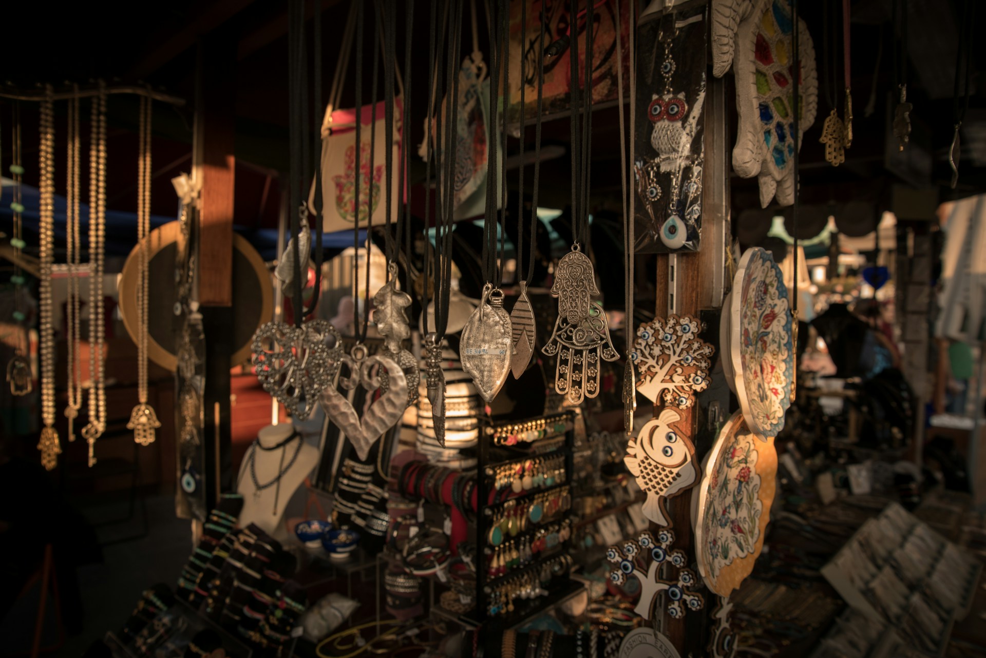 Handmade crafts and jewelry displayed at a market stall.