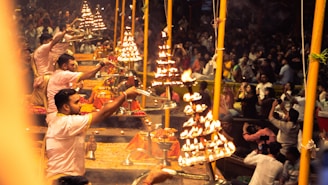 People performing a ritual with lamps at night