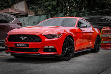 A red ford mustang parked outside