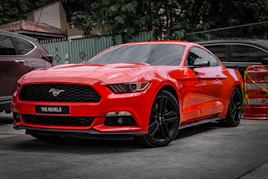 A red ford mustang parked outside