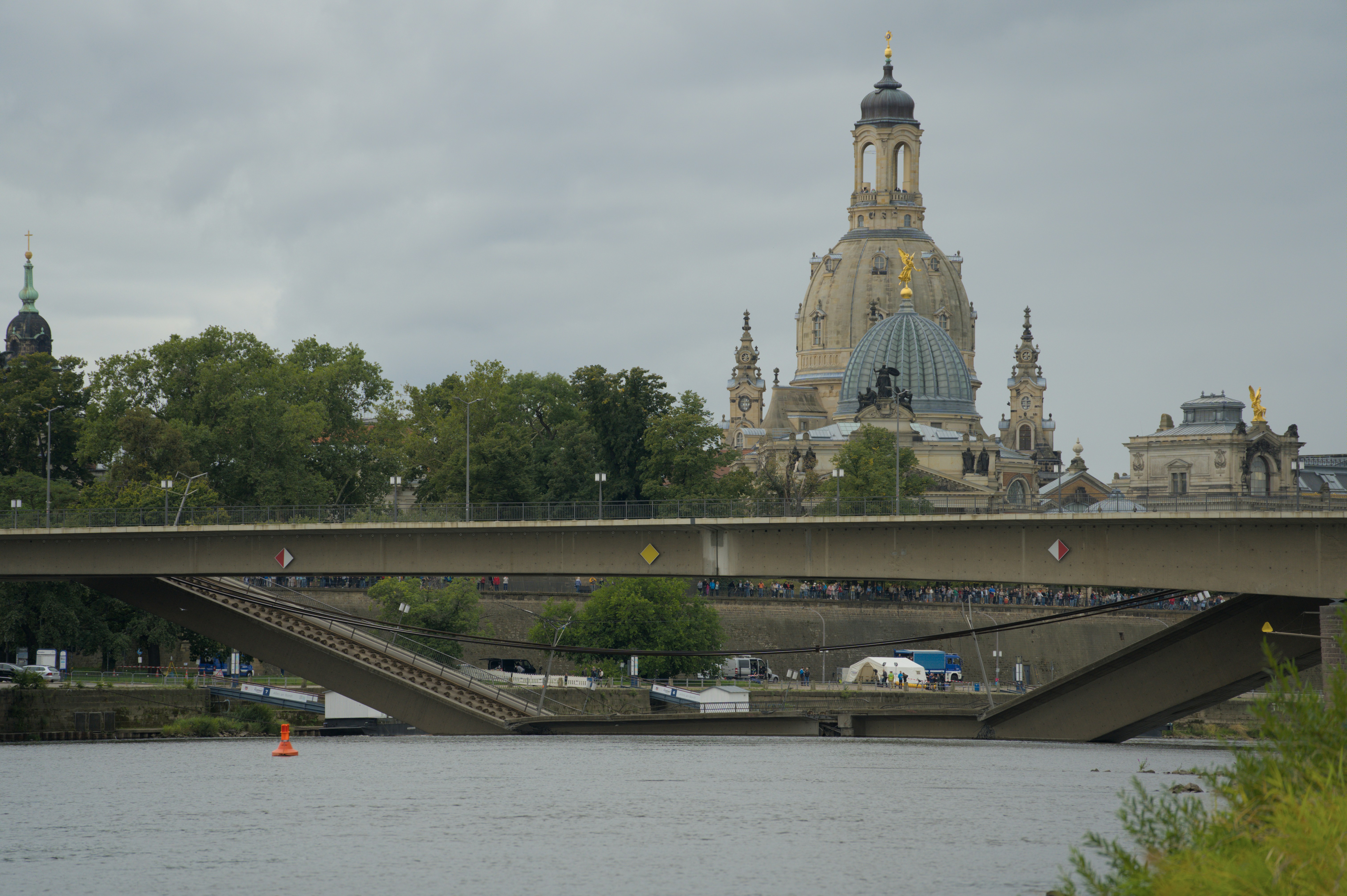 Bridge over river with historic buildings in background