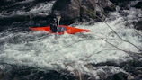 A kayaker navigates white water rapids.