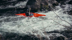 A kayaker navigates white water rapids.