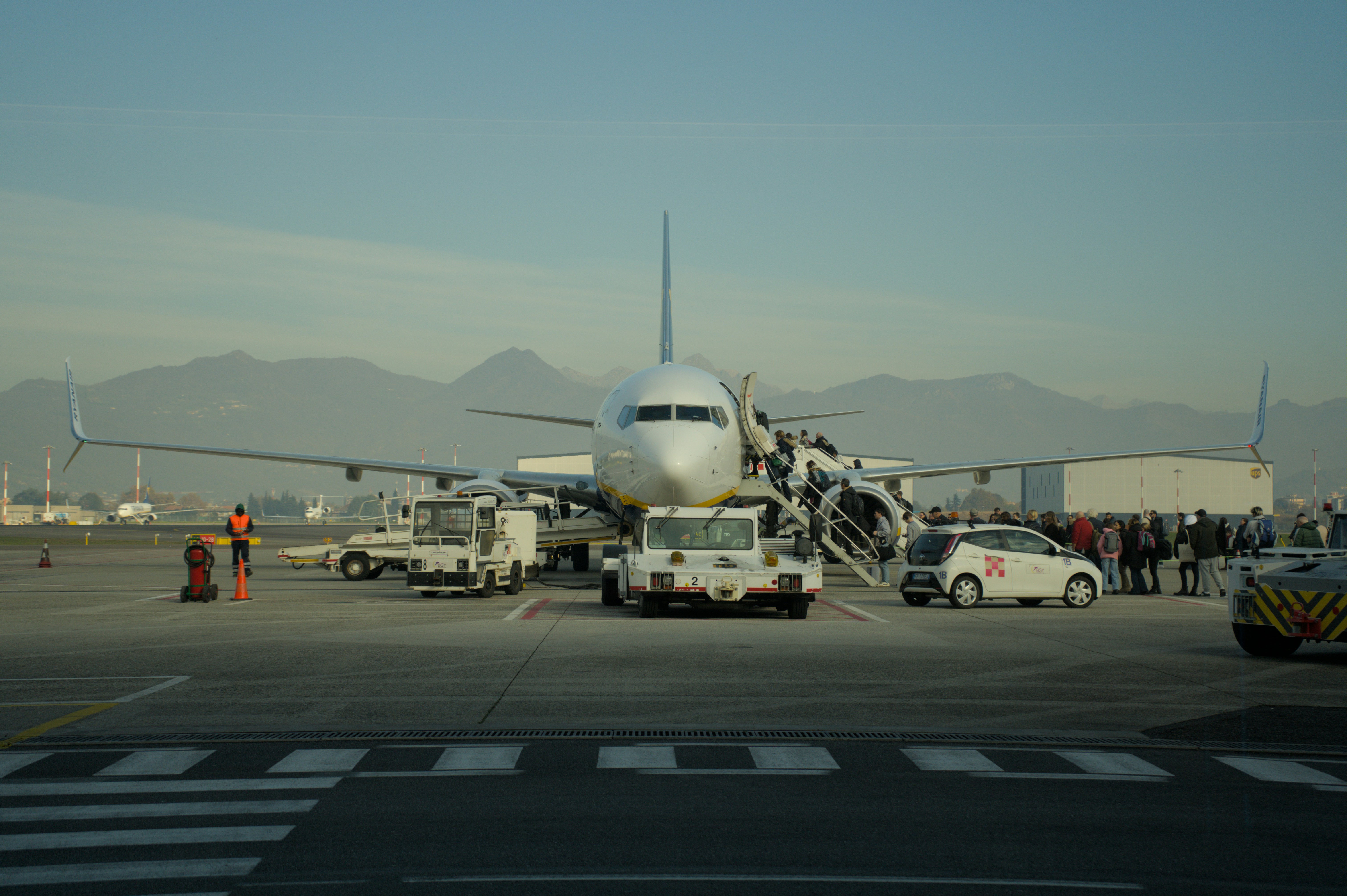 Passengers boarding an airplane at an airport.