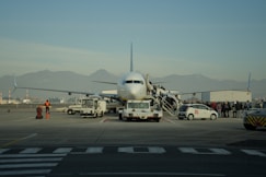 Passengers boarding an airplane at an airport.