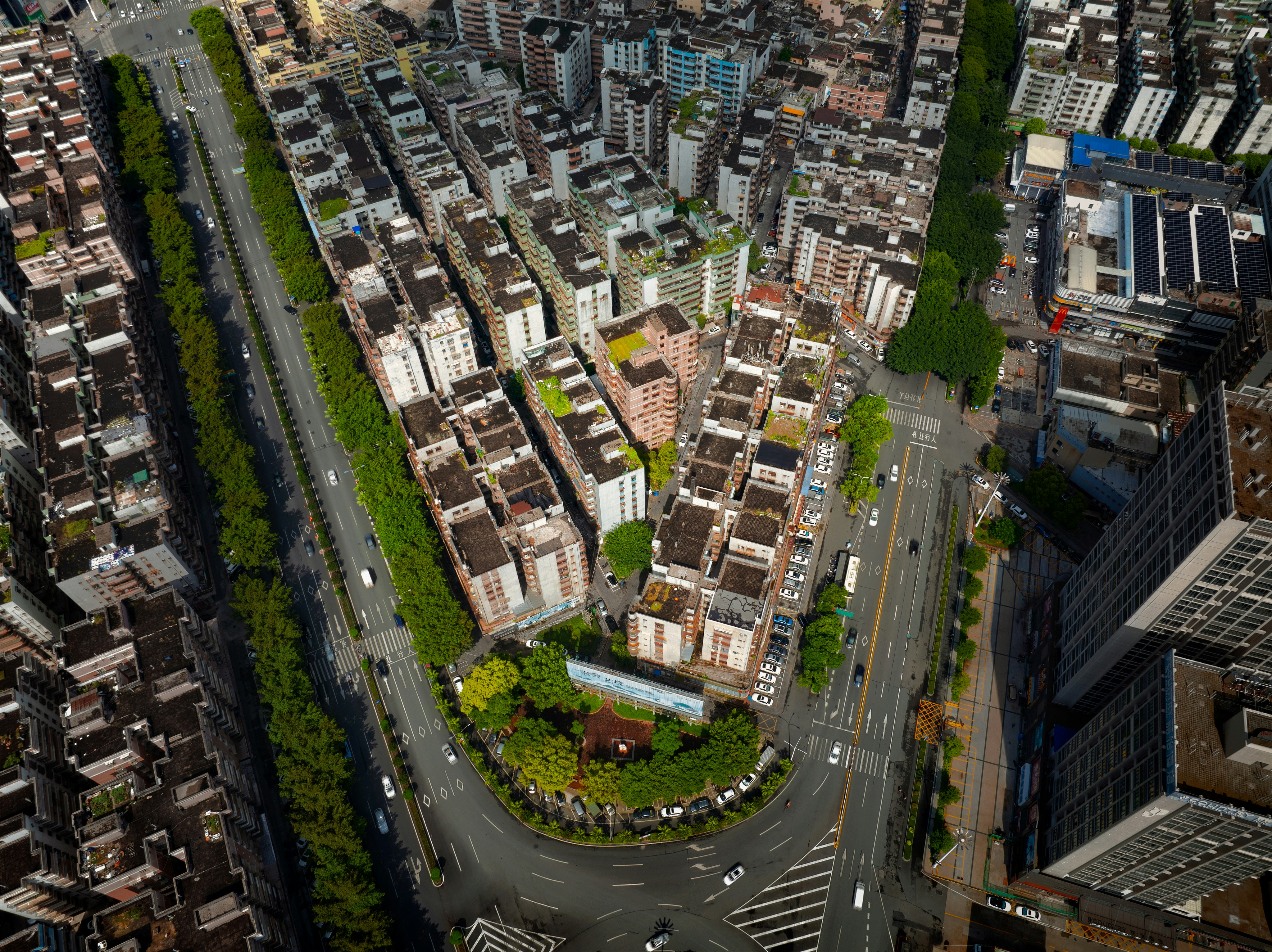 Aerial view of dense urban housing and streets.