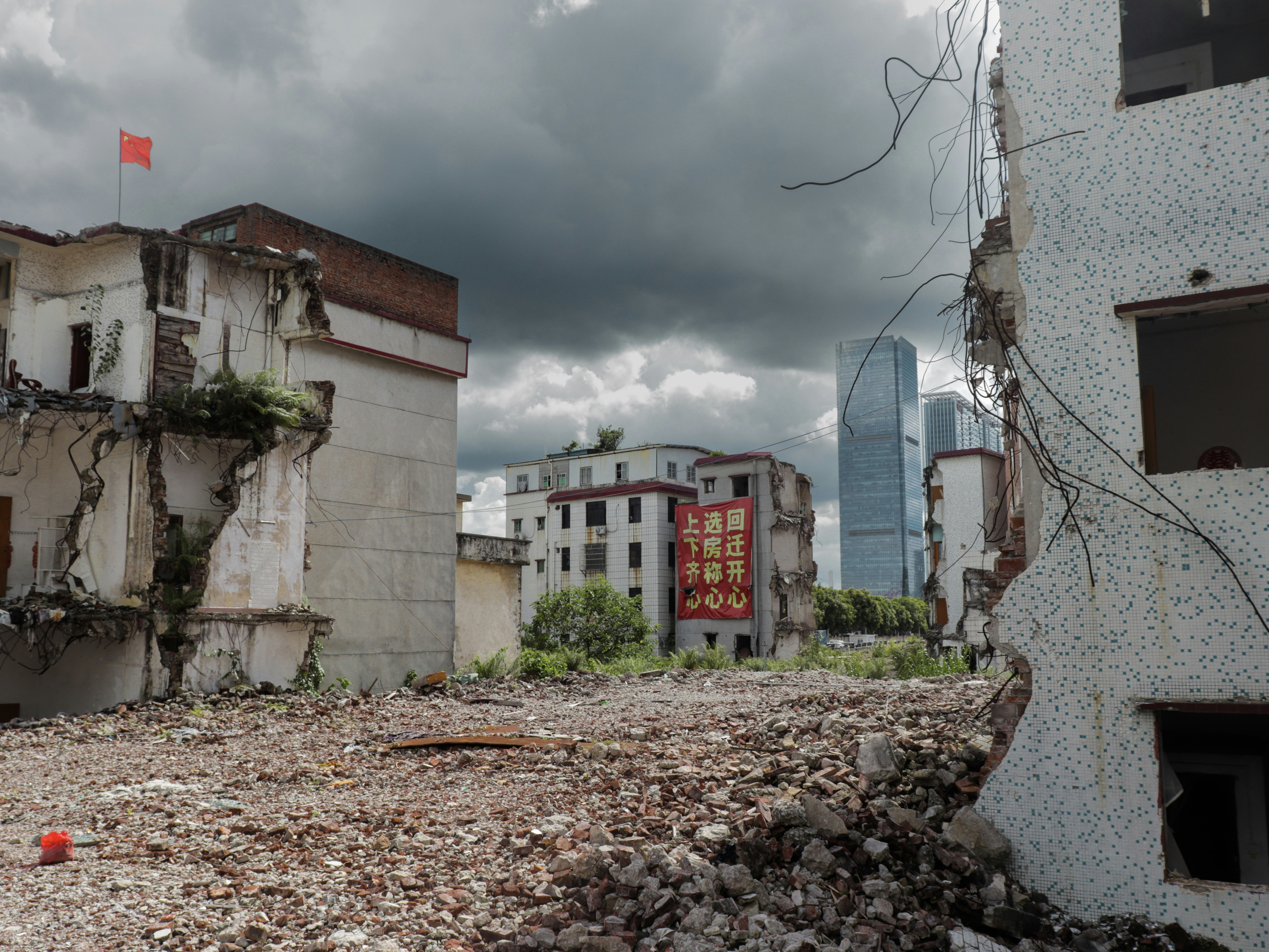 Demolished buildings with modern skyscrapers in background