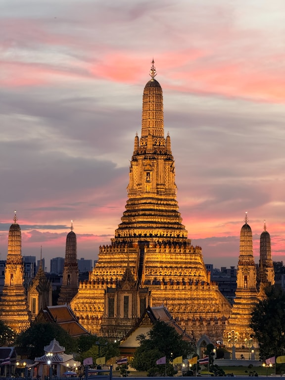 Golden temple illuminated against a colorful sunset sky