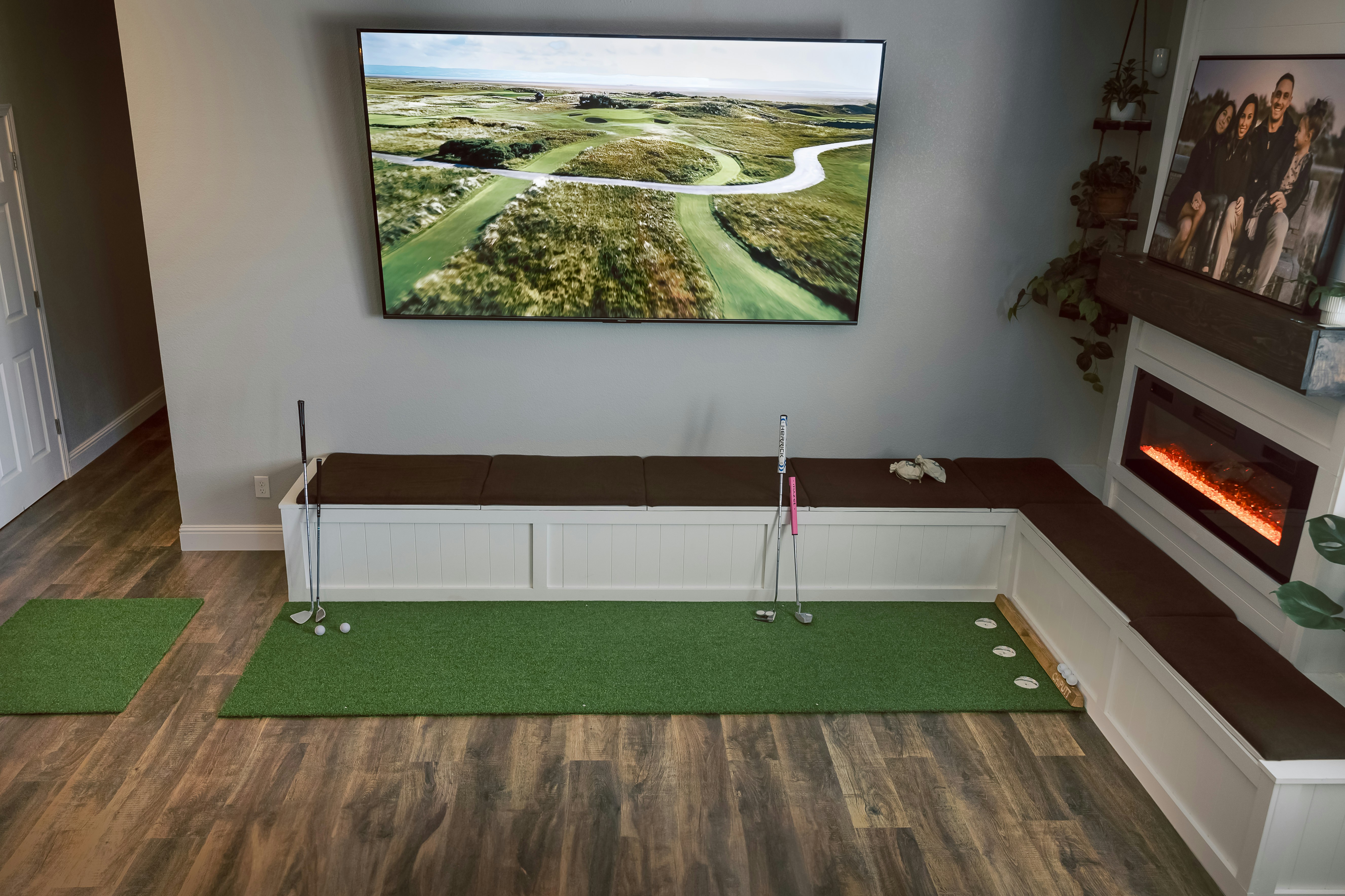 Indoor putting green with golf on television screen