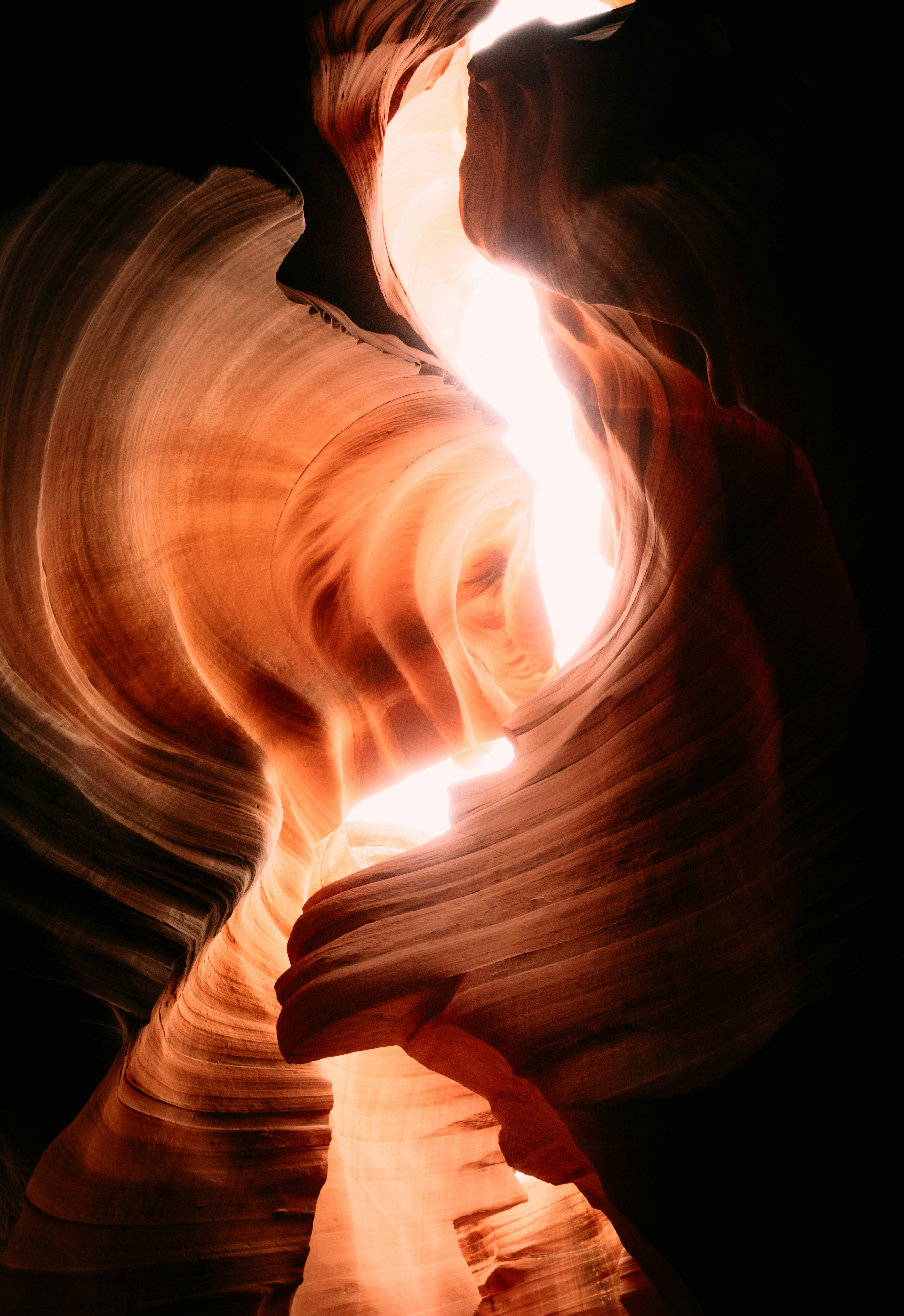 Light streams through a narrow sandstone canyon.