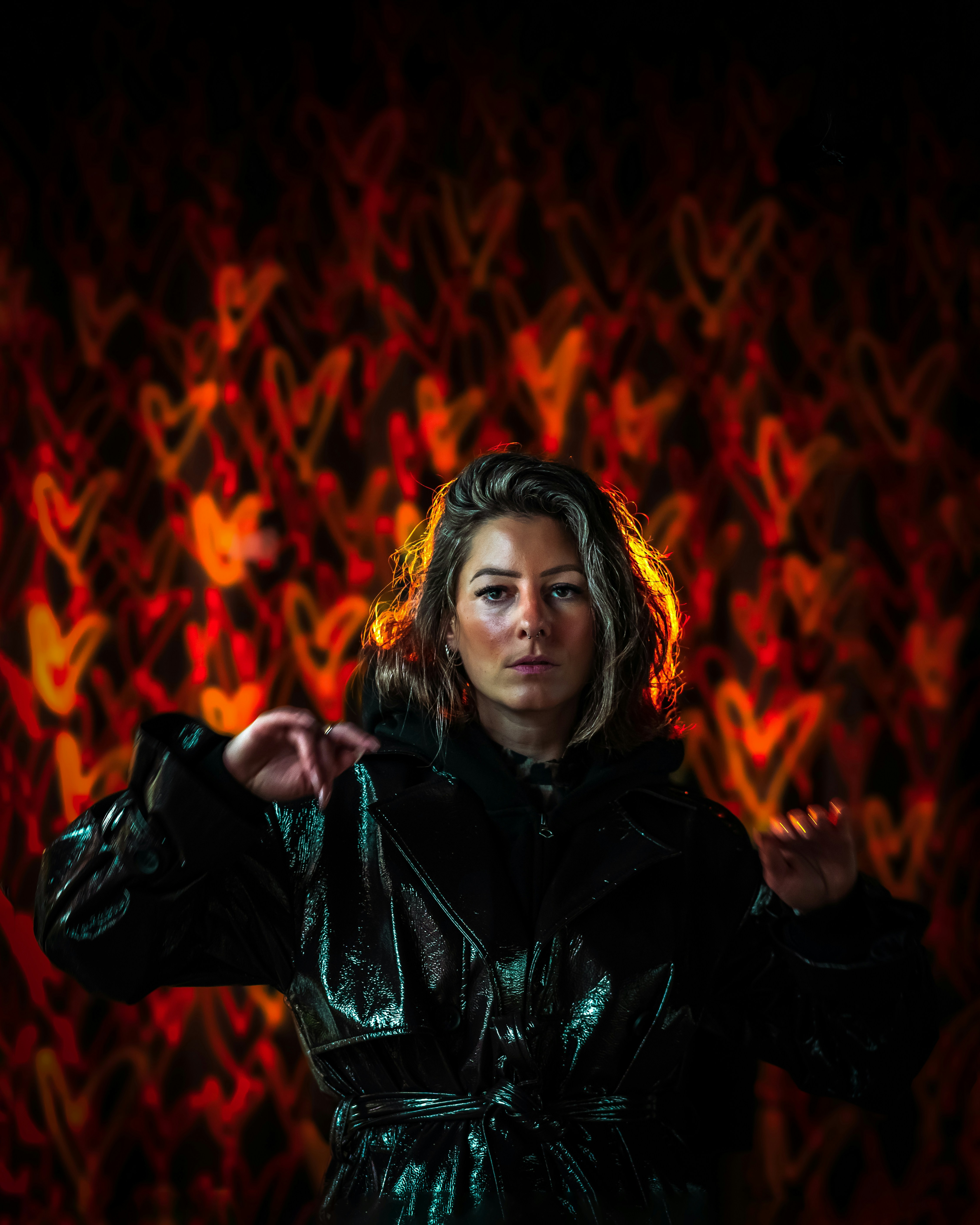 Woman in shiny jacket with heart bokeh background