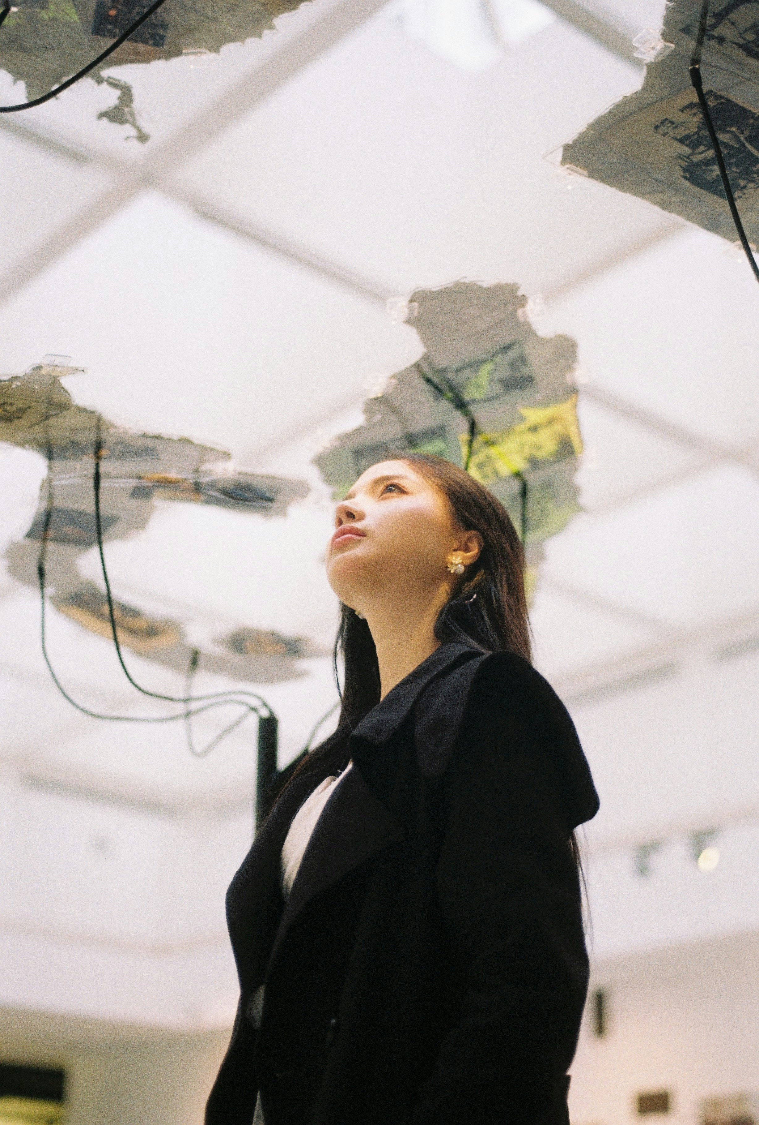 Woman looking up at an art installation