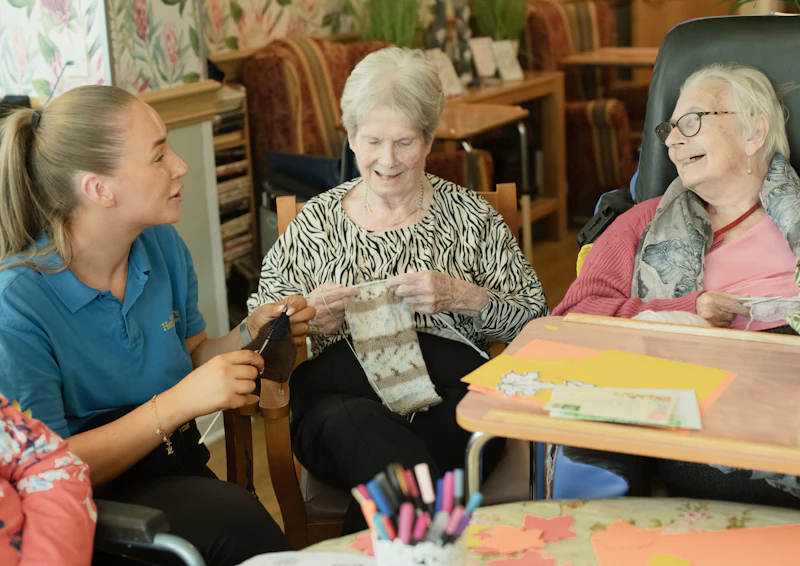 Caregiver and elderly client reviewing documents together at a table