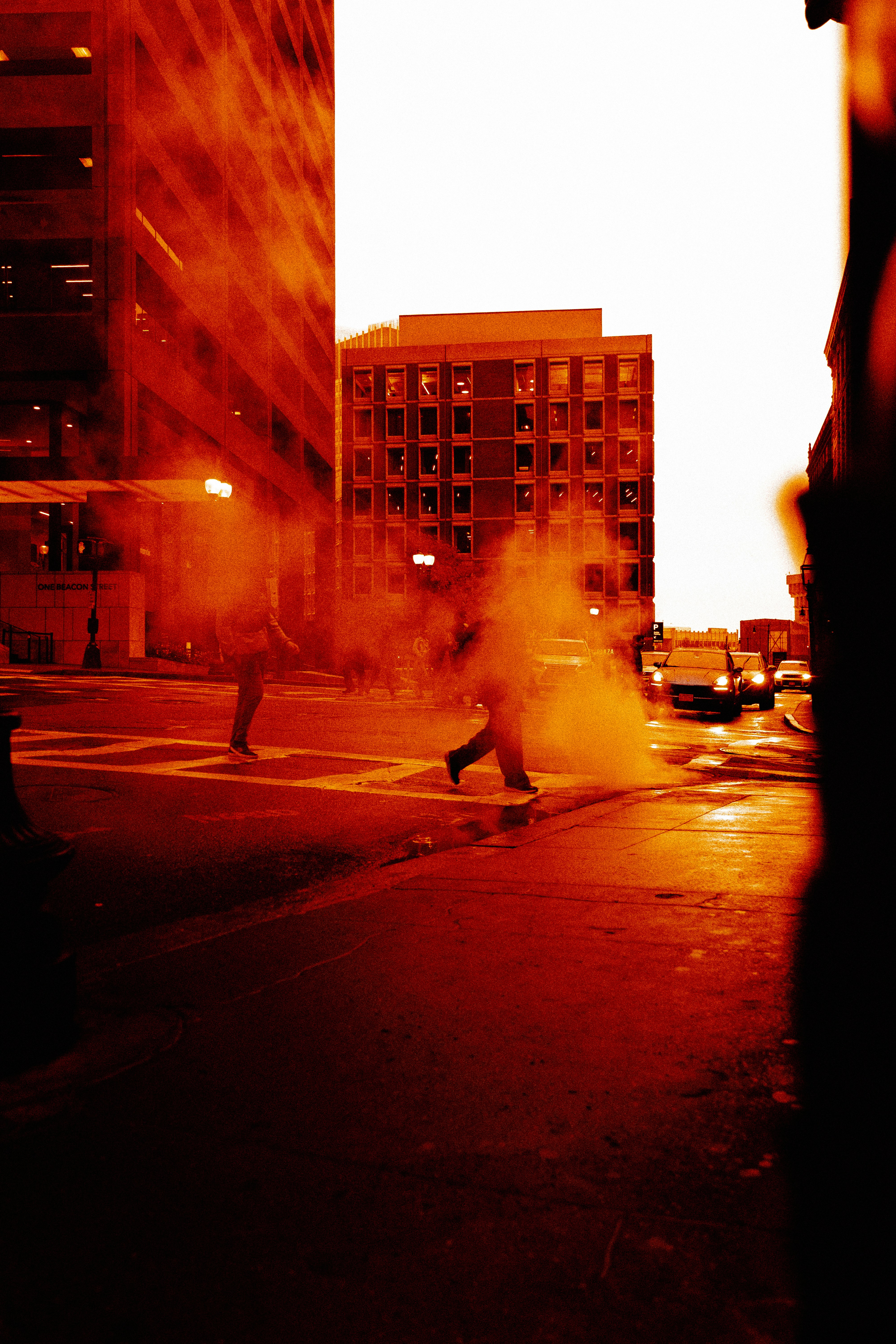 People crossing street with steam in urban setting