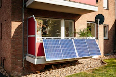 Solar panels on a brick building balcony.