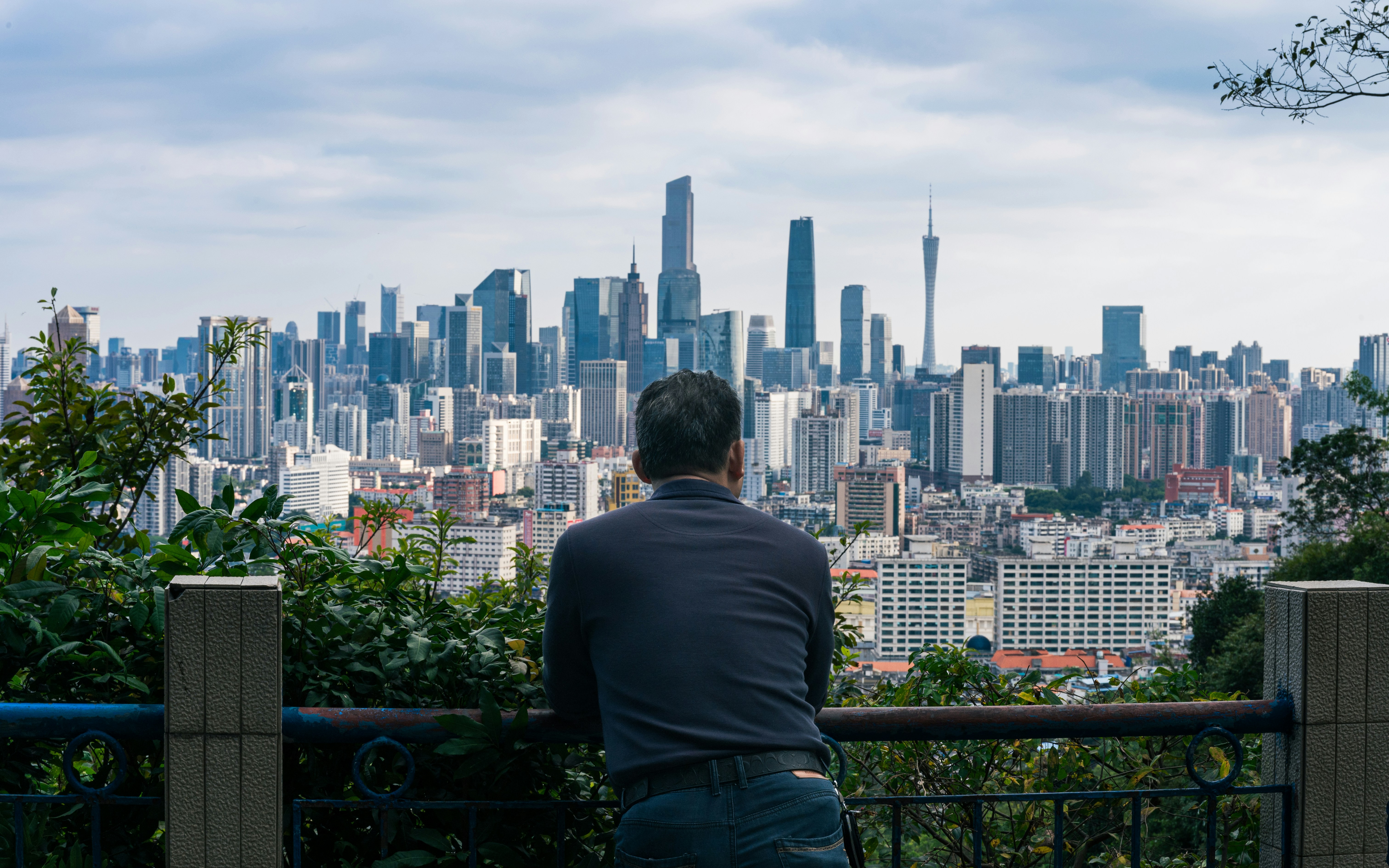 Man looking at a sprawling city skyline
