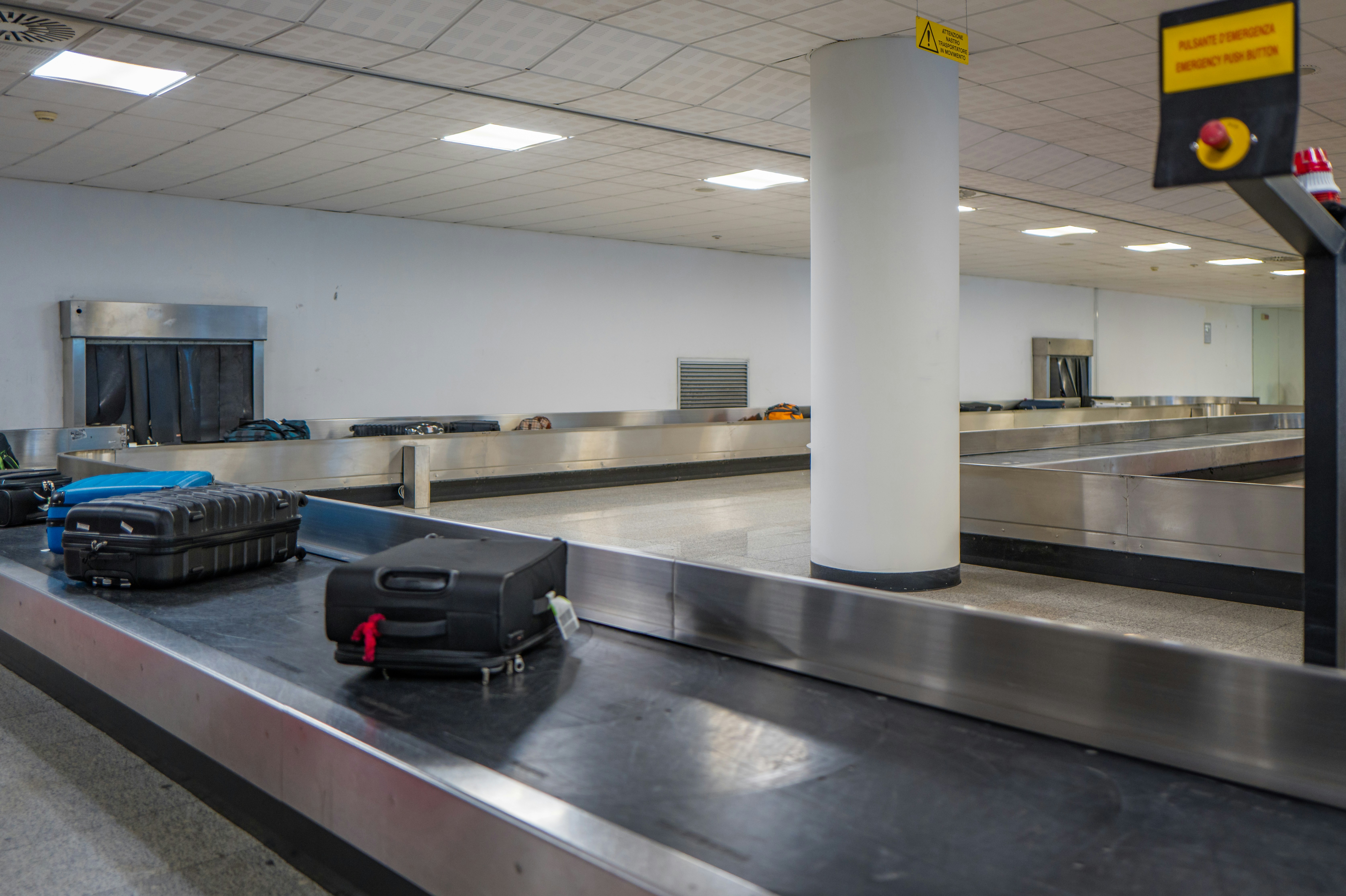 Luggage on a conveyor belt at an airport baggage claim.