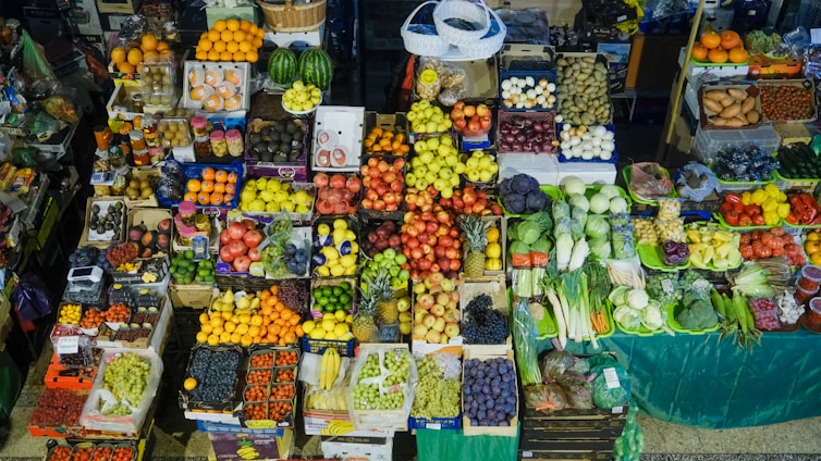 Colorful fresh fruits and vegetables displayed at market stalls.