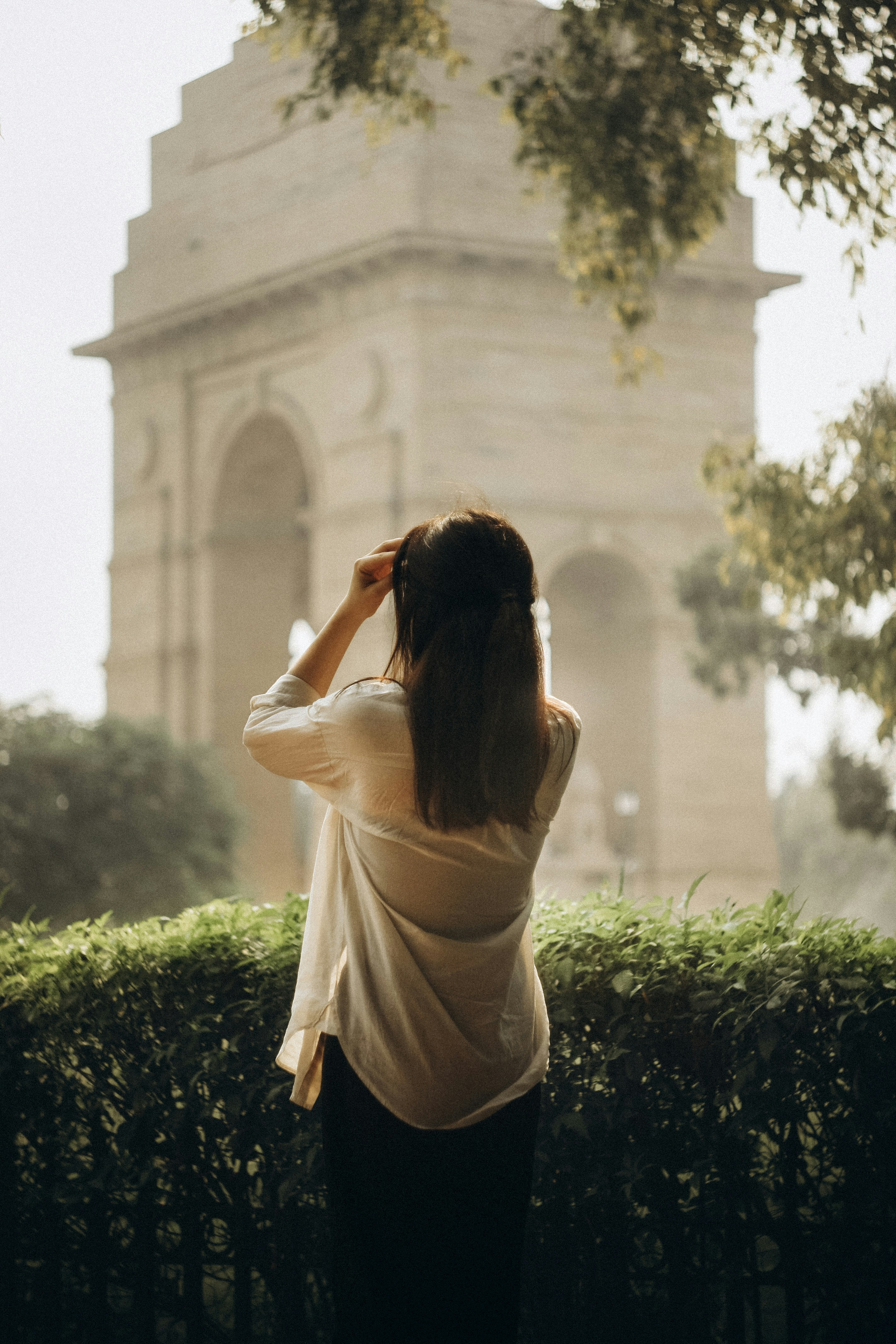 Woman looking at india gate monument in new delhi.