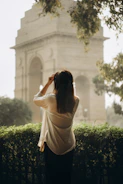 Woman looking at india gate monument in new delhi.
