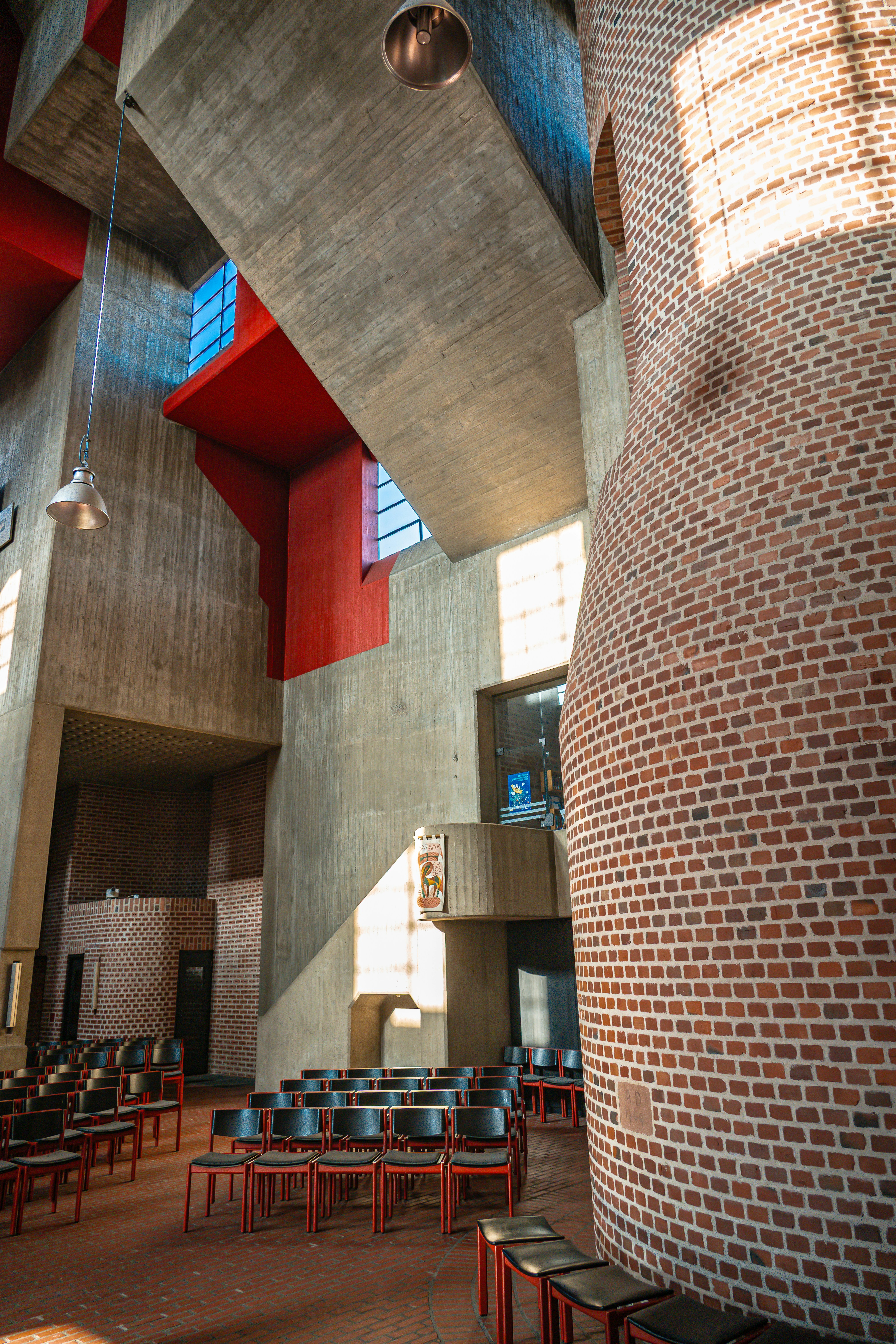 Modern brutalist church interior with concrete and brick.