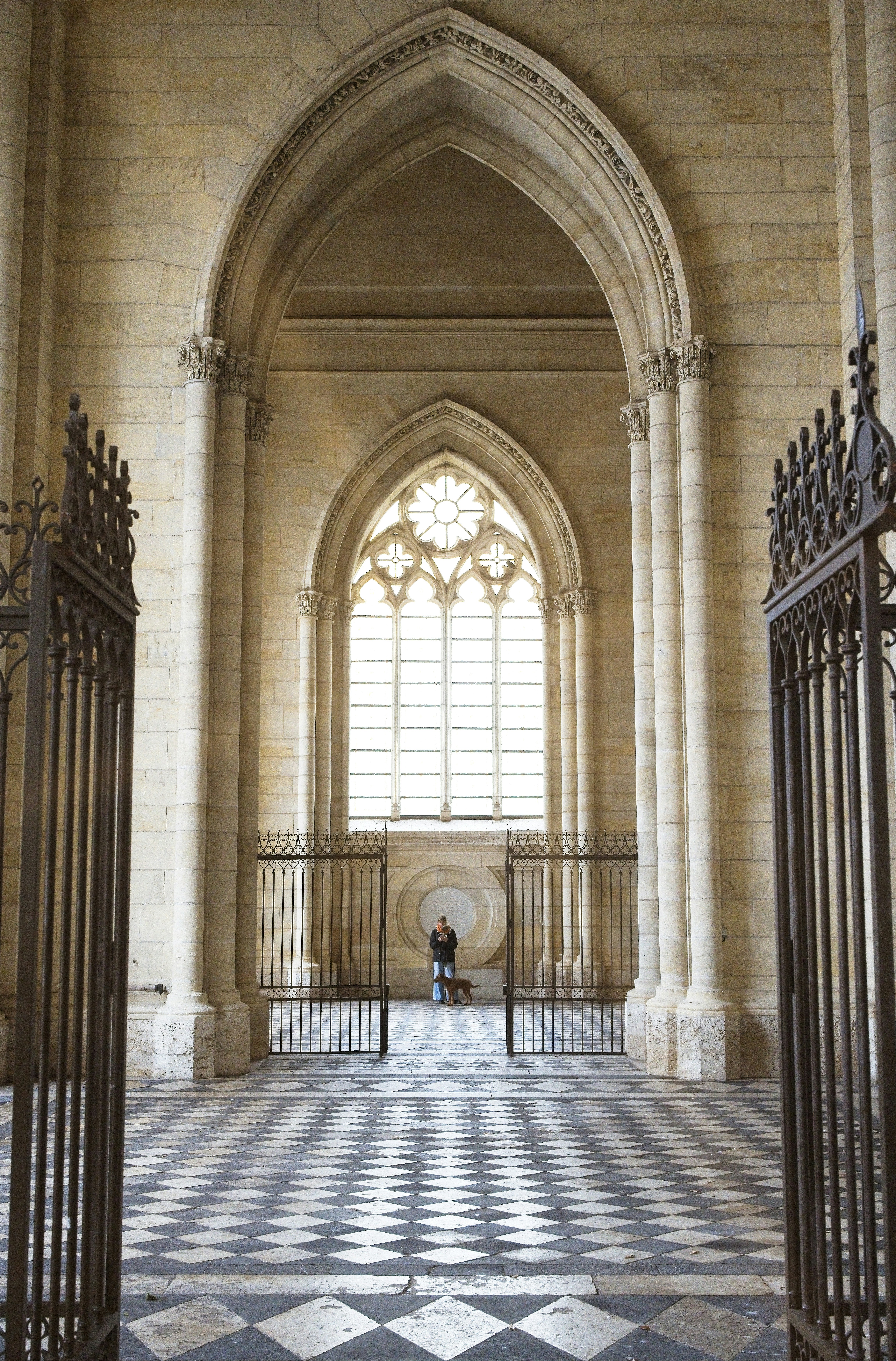 Grand archway with large window and checkered floor