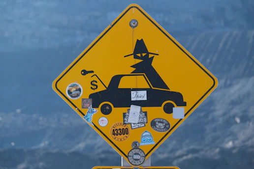 Yellow diamond sign with silhouette of car and spy.