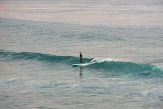 Surfer riding a wave in the ocean.
