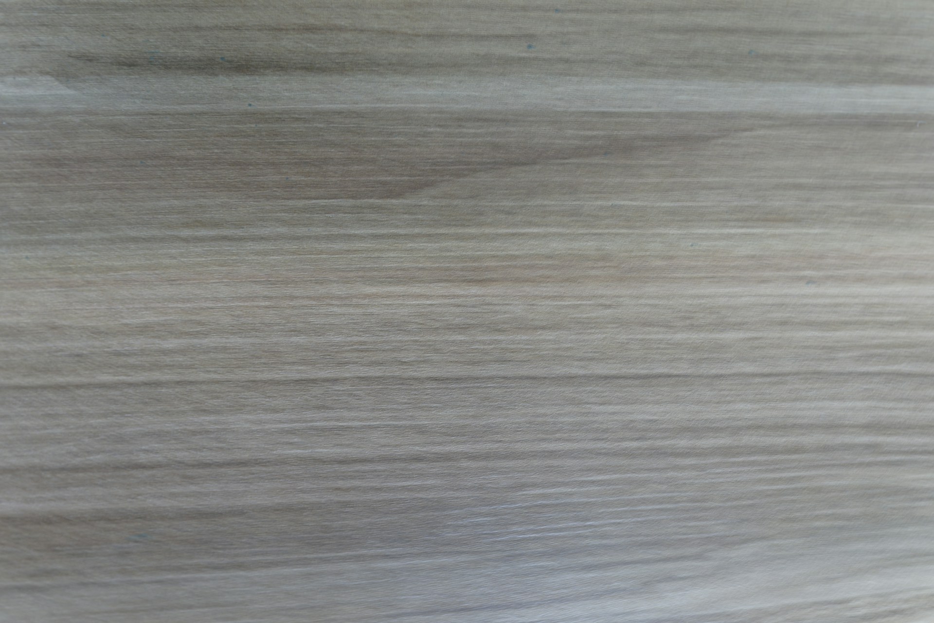 A close-up of a light brown wood grain texture.