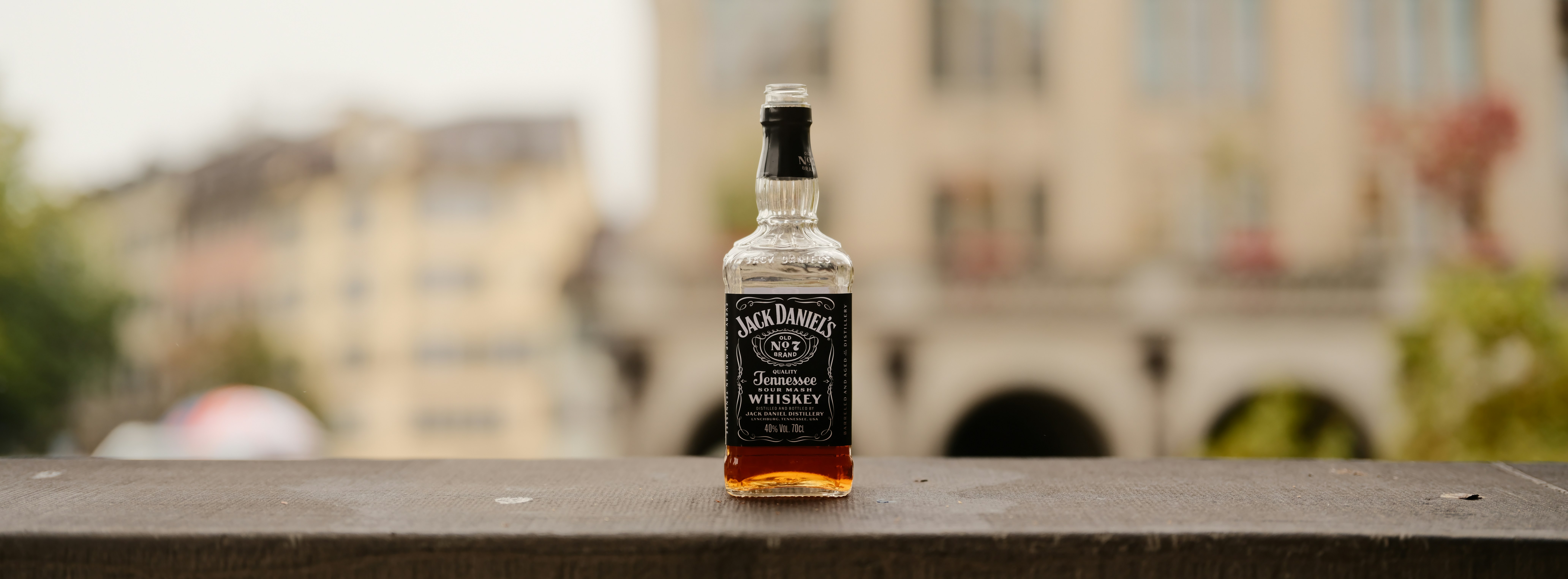 A bottle of jack daniels whiskey on a ledge.