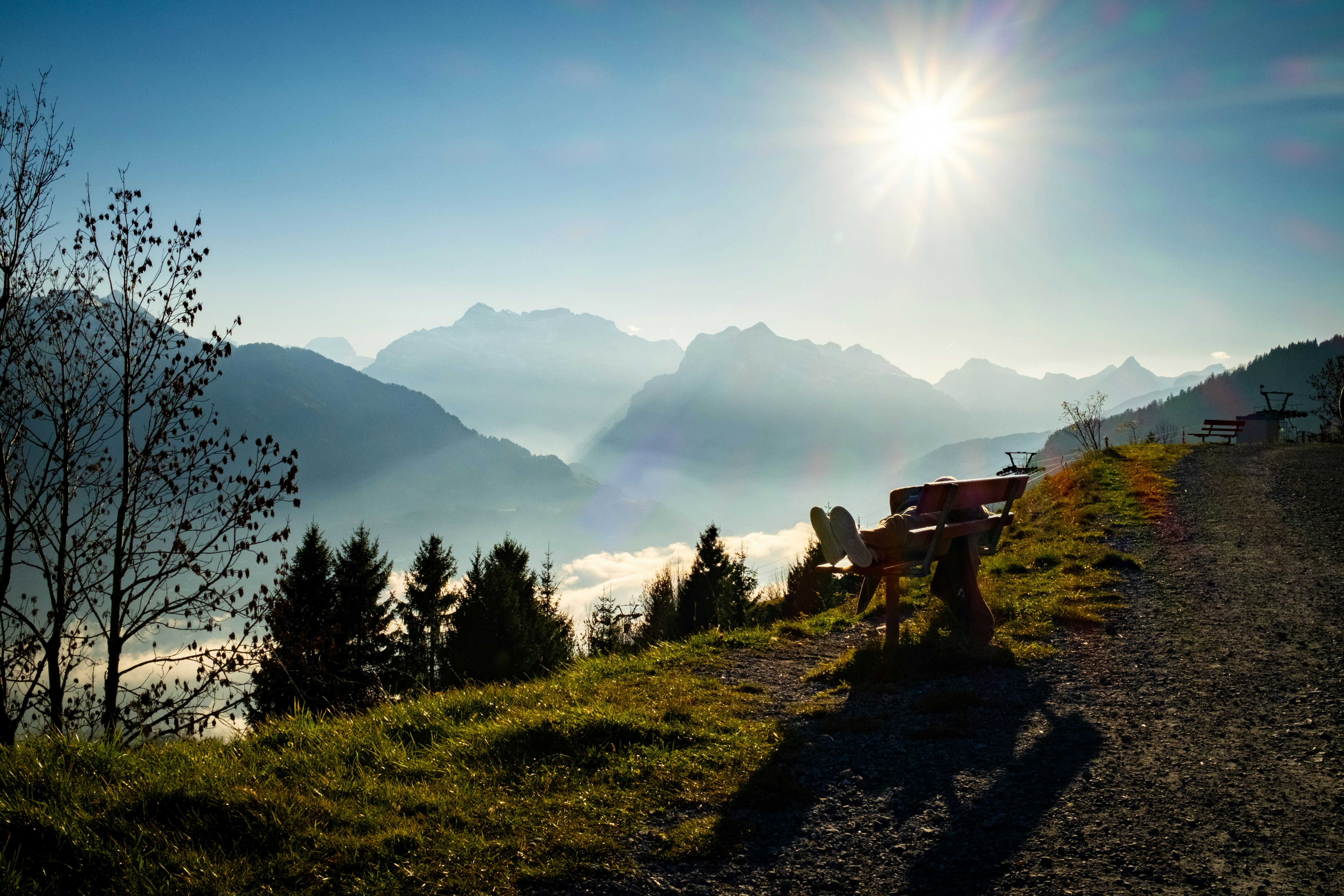 Sunny mountain landscape with a wooden bench