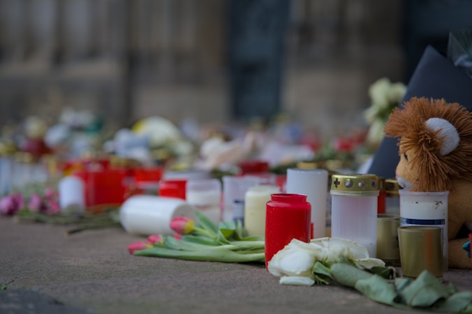 Candles and flowers laid out as a memorial tribute, the kind of display used at annual September 11 remembrance ceremonies